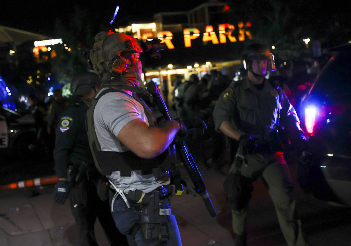 A man who appears to be impersonating a federal agent stands among Las Vegas police officers du ...