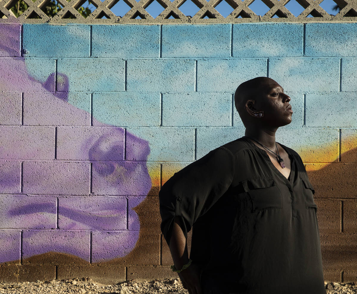 Fine artist and Illustrator Lance Smith in front of a mural they completed for the Bazar Alley ...