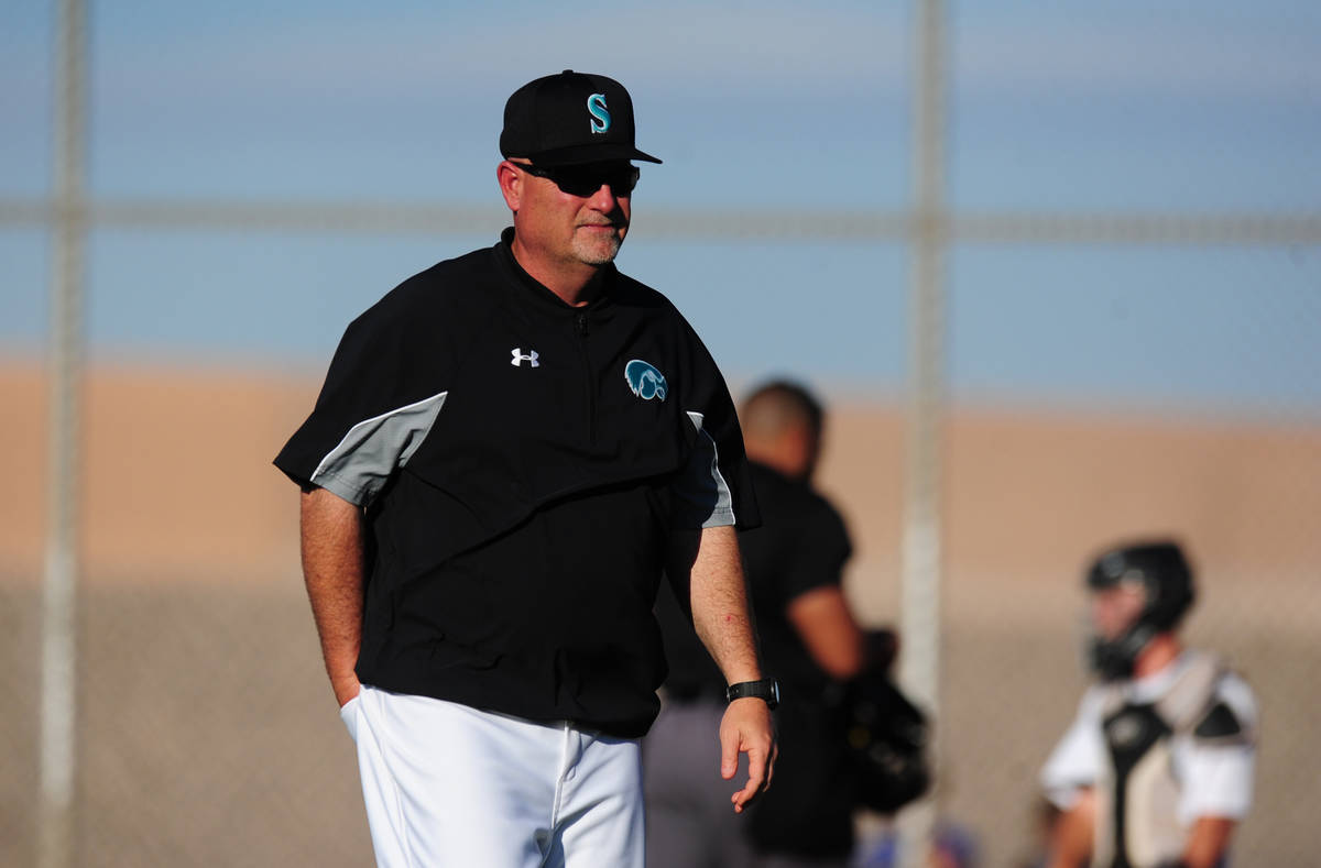 Silverado head coach Brian Whitaker walks to the dugout after making a pitching change in the s ...