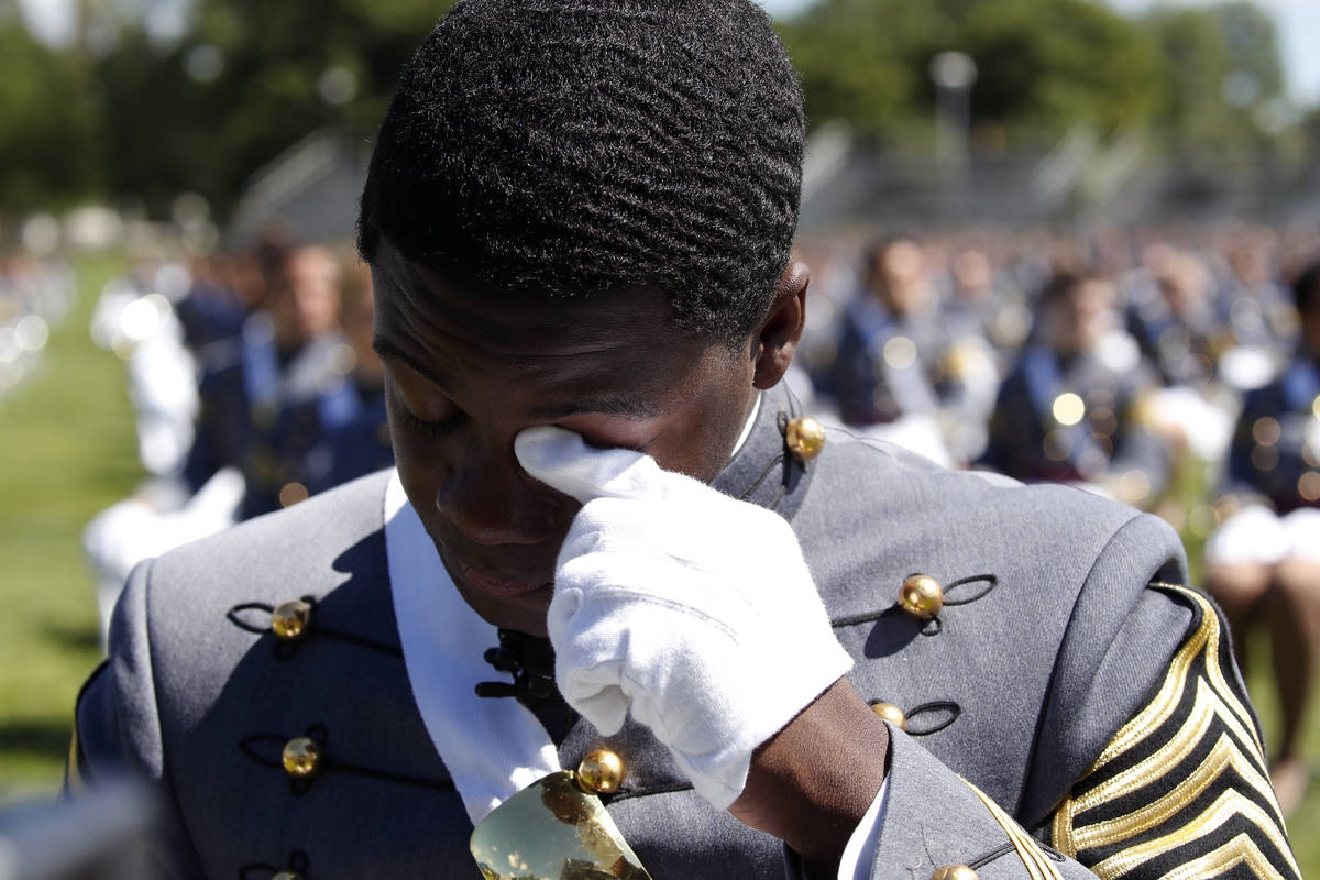 West Point Class President Cadet Joshua Phillips, from Chicago, wipes a tear during the musical ...