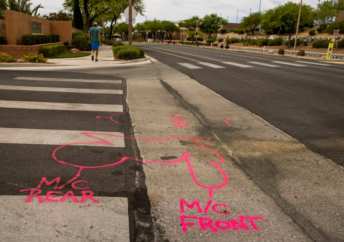 Police spray paint outlines on the road mark where two teen brothers were killed in a recent mo ...