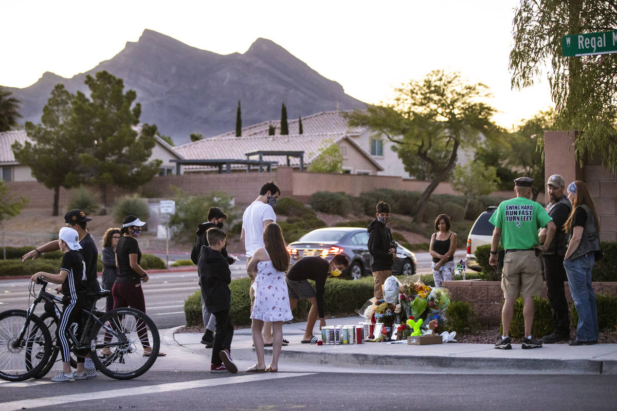 People gather for a vigil in memory of David Cox, 18, and Brandon Cox, 14, brothers who were ki ...