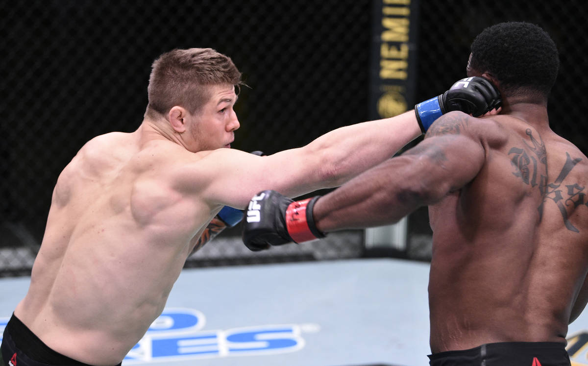 LAS VEGAS, NEVADA - JUNE 13: (L-R) Marvin Vettori of Italy punches Karl Roberson in their middl ...