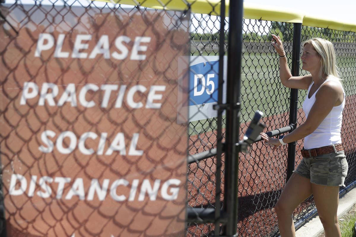 Kate Nunley watches as professional and college players workout at Grand Park, Friday, June 12, ...