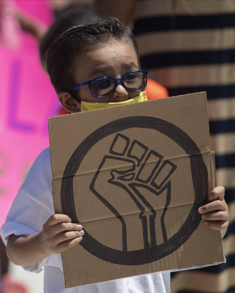 Benjamin Sanchez, 6, marches in the "Kids Against Racism Rally" at Craig Ranch Region ...