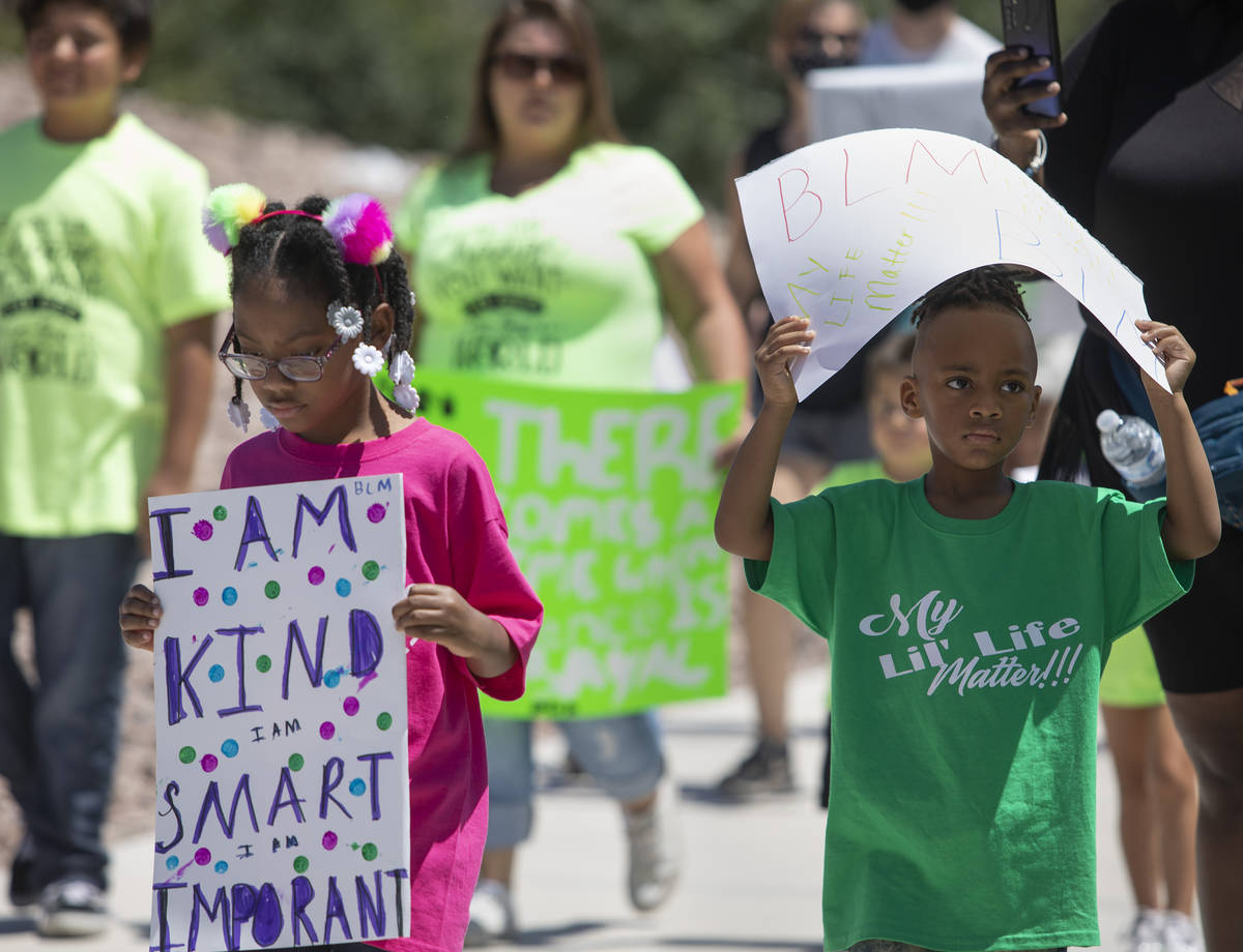 Camryn Bolden, 5, left, marches alongside her cousin Ashton Pollard, 5, right, during the &quot ...
