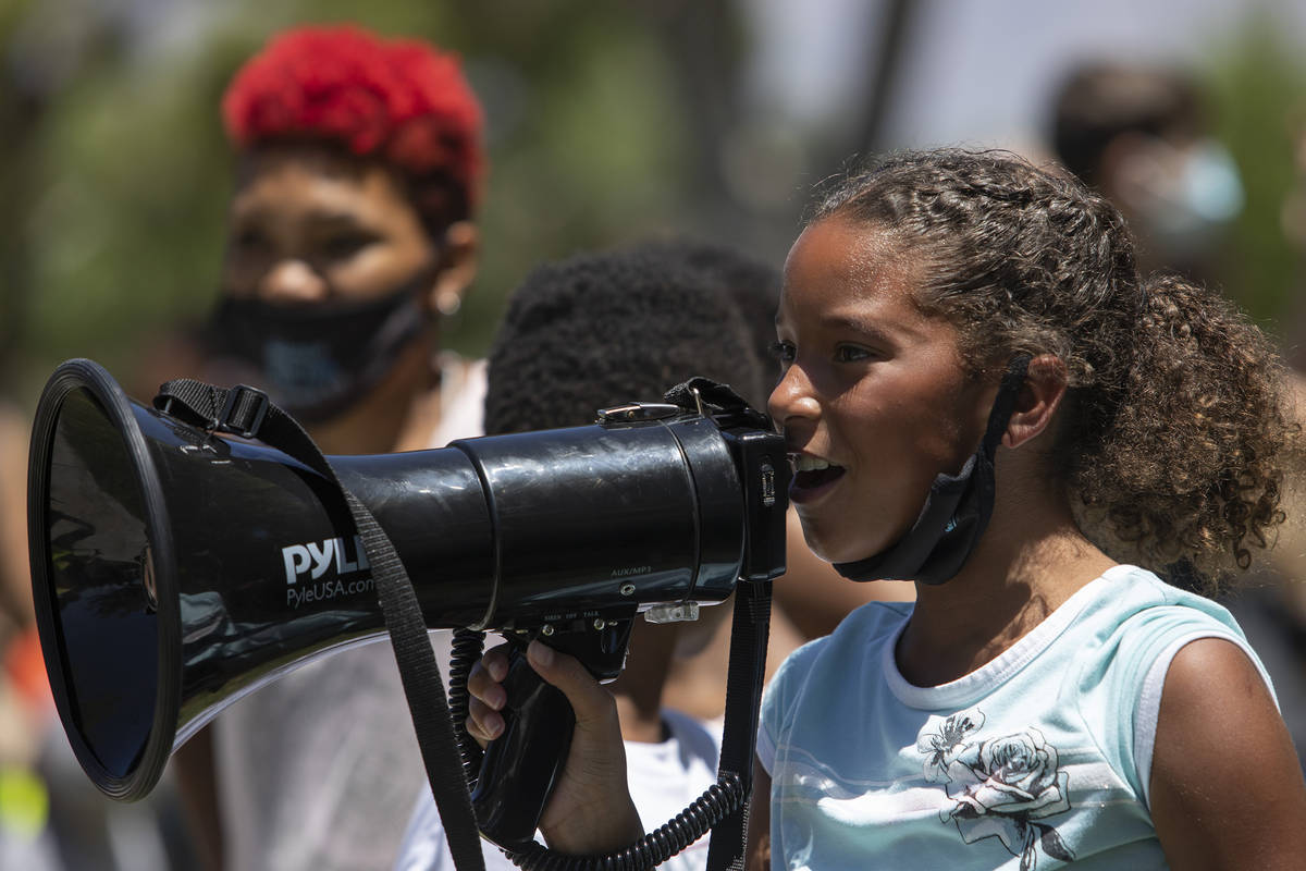 Paige Faggins, 9, takes a turn to chant into the megaphone at the "Kids Against Racism Ral ...