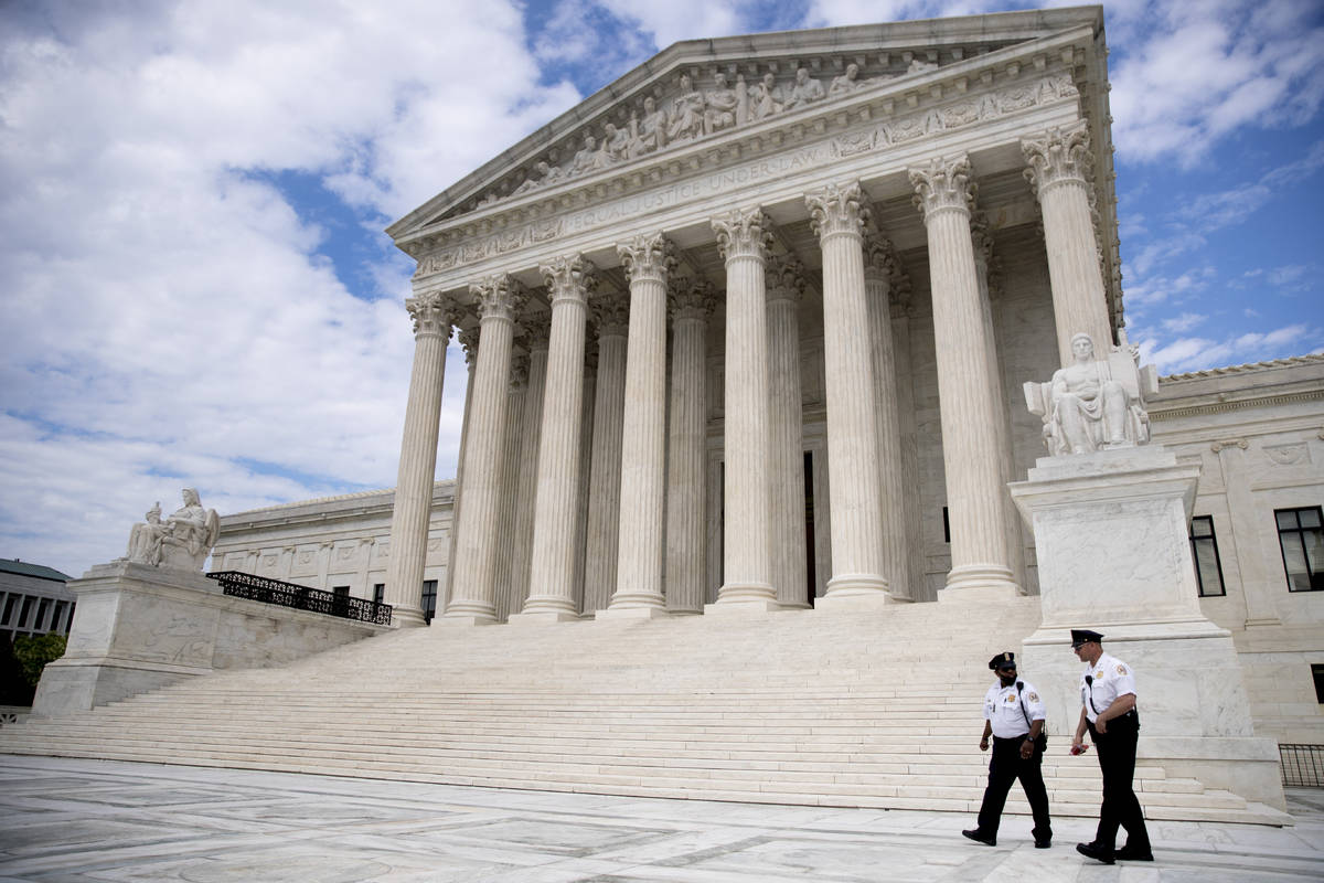 FILE - In this May 14, 2020, file photo security officers walk in front of the Supreme Court in ...