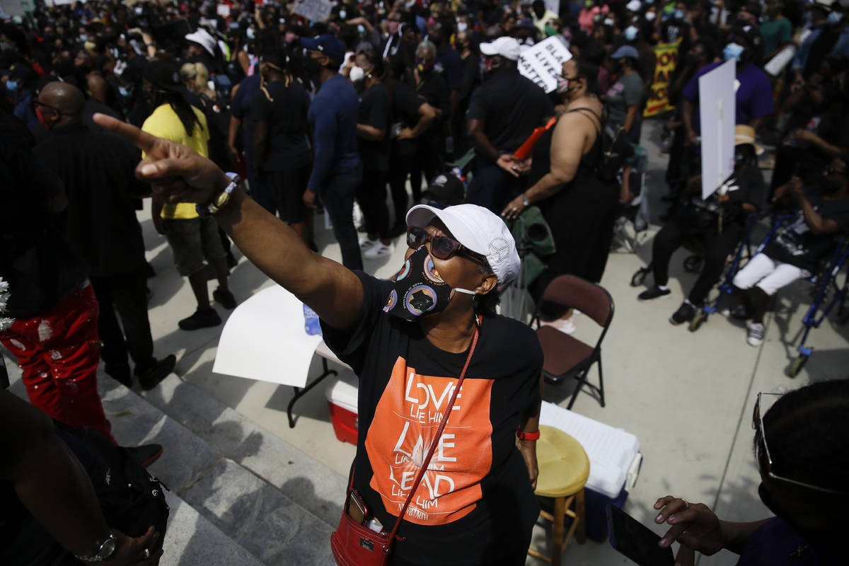 People march down the street during the NAACP's “March on Georgia” protest that c ...