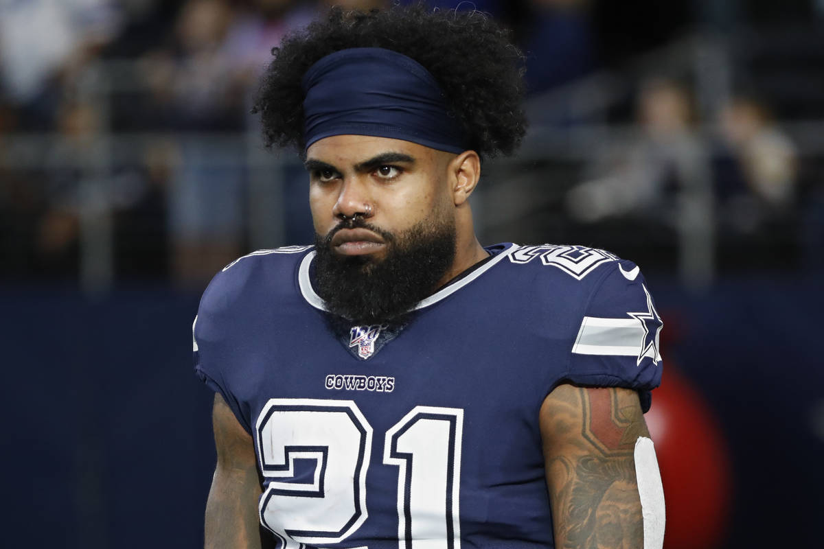 FILE - In this Dec. 15, 2019, file photo, Dallas Cowboys running back Ezekiel Elliott (21) warm ...