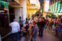 People enter the Golden Nugget at 12:01 a.m. as hotel-casinos reopen in downtown Las Vegas on T ...