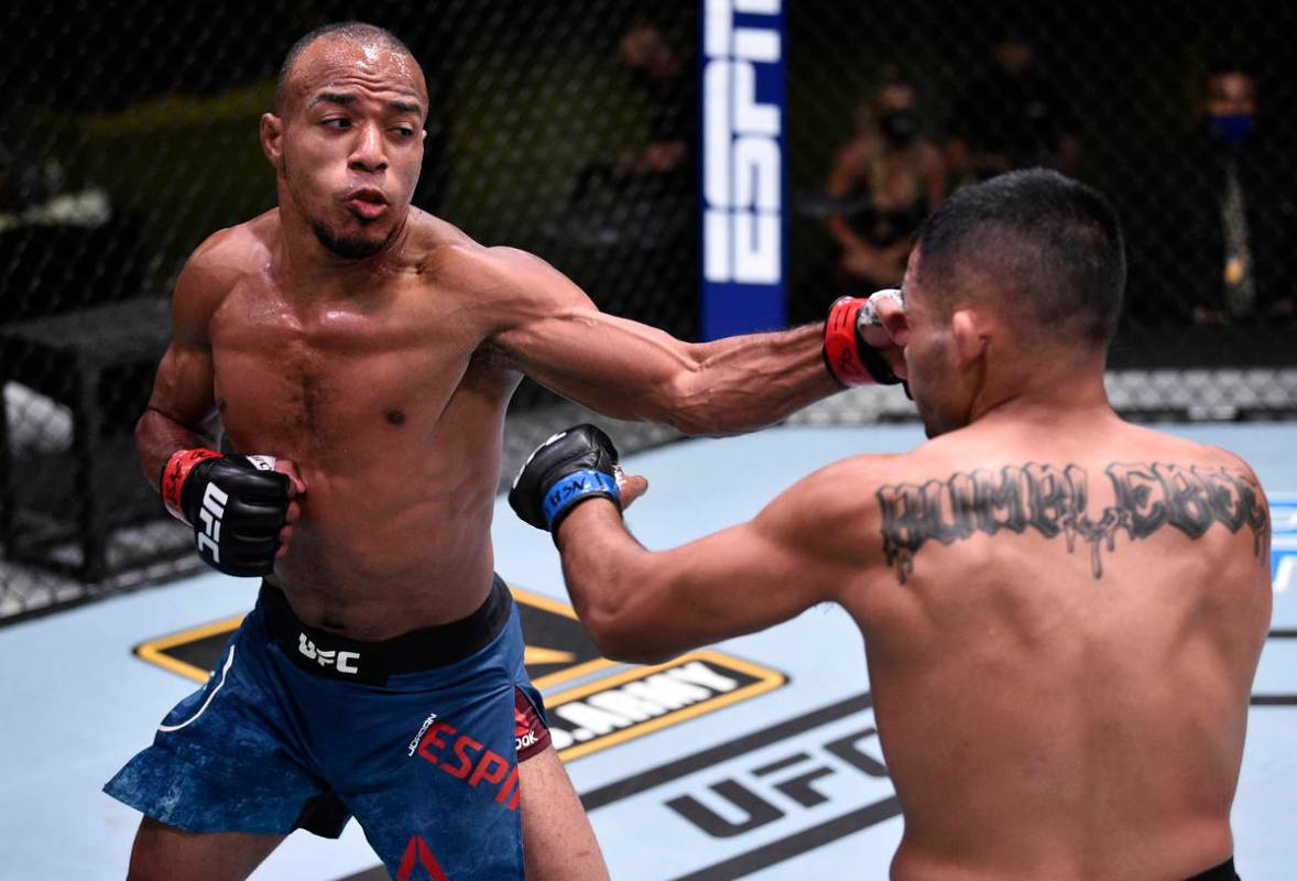 Jordan Espinosa punches Mark De La Rosa in their bantamweight fight during the UFC Fight Night ...