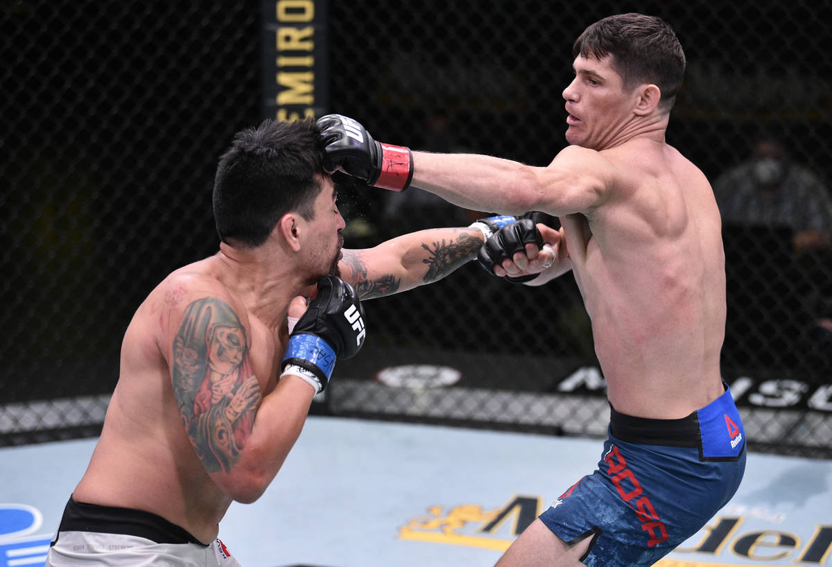 Charles Rosa punches Kevin Aguilar in their lightweight fight during the UFC Fight Night event ...