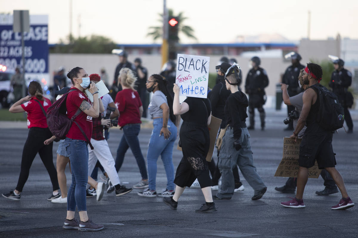 One legal observer makes a phone call during a protest against police brutality on Saturday, Ju ...