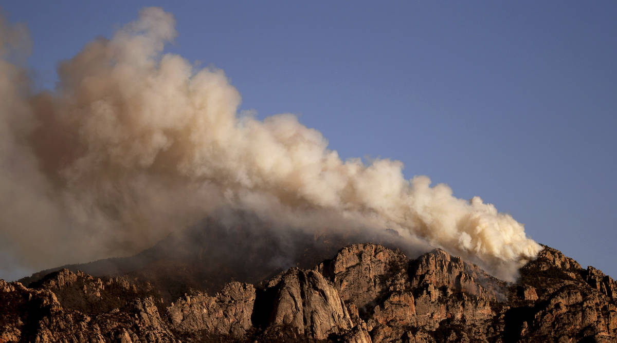 A stiff wind out of the southwest pushes the Bighorn Fire into the central Santa Catalina Mount ...