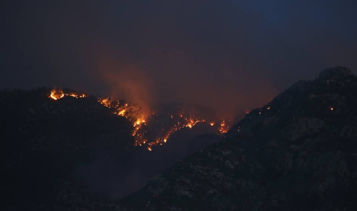 The Bighorn Fire moves along the western side of the Santa Catalina Mountains, Sunday, June 14, ...