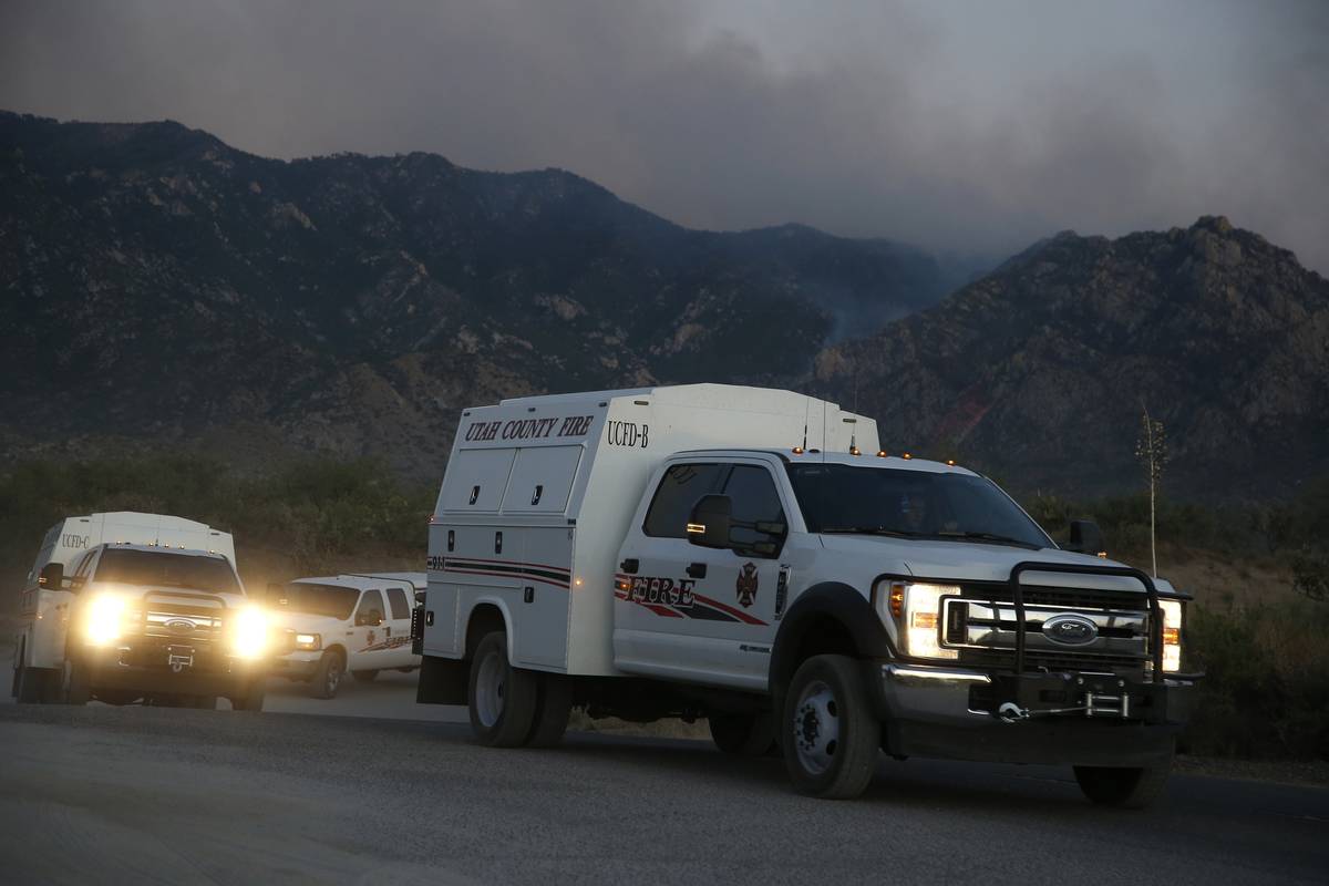 Fires crews move to another location as they battle the Bighorn Fire along the western side of ...