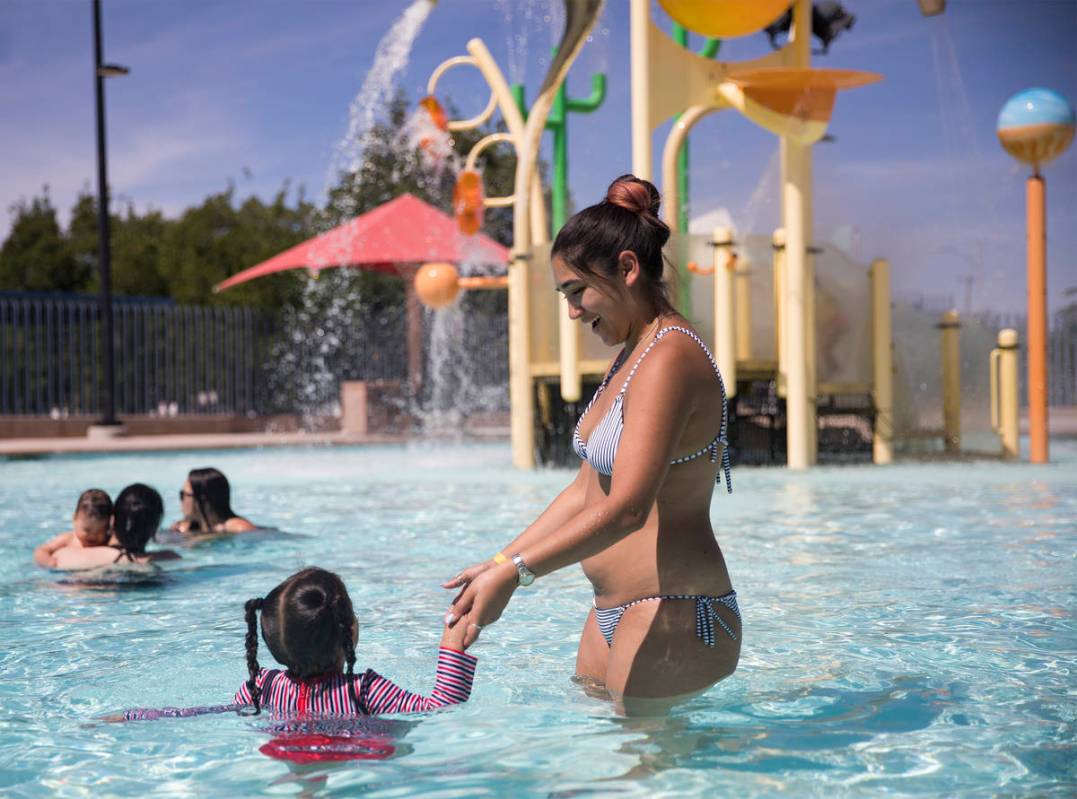 Zhasani Myers plays with her daughter Zarah Mitchell, 3, at Garside Pool in Las Vegas, Monday, ...