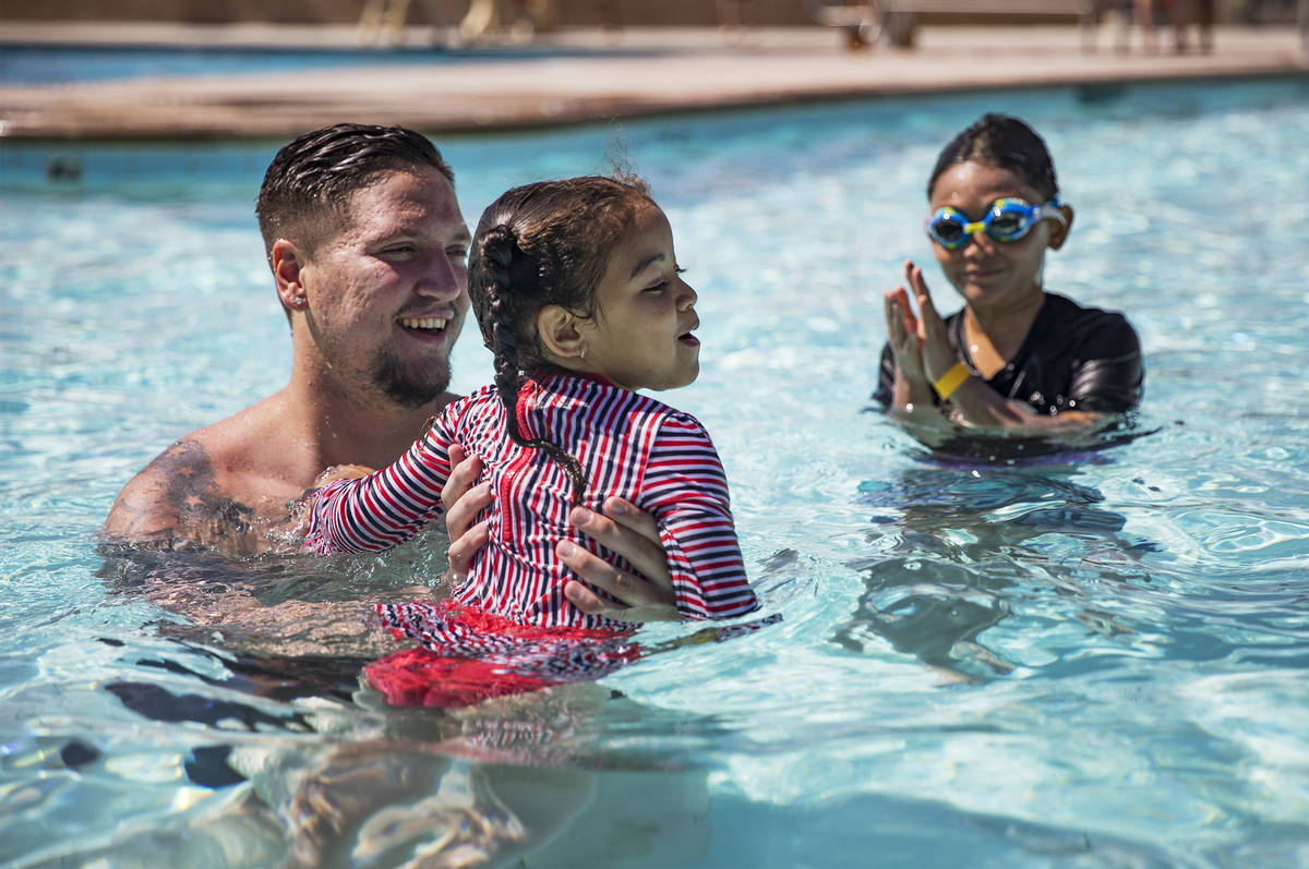 Terry Sharp, from left, plays with Zarah Mitchell, 3, and MitchellÕs brother Tristyn Kasog ...