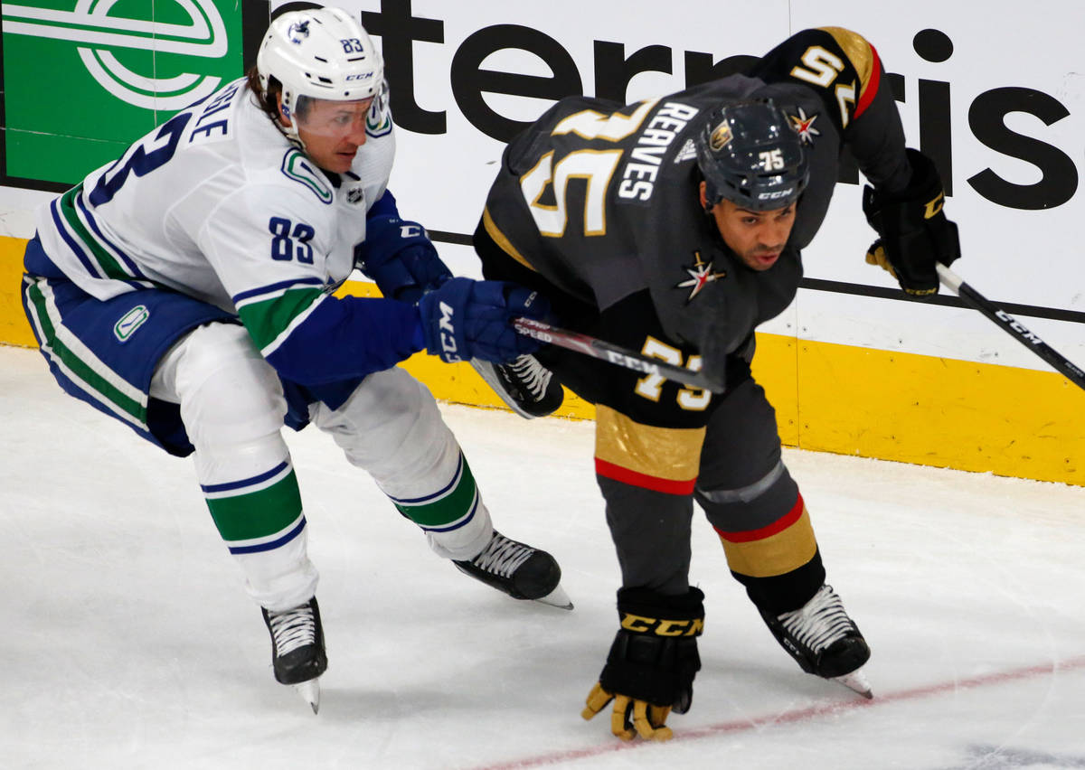 Vancouver Canucks center Jay Beagle (83) competes with Vegas Golden Knights right wing Ryan Rea ...
