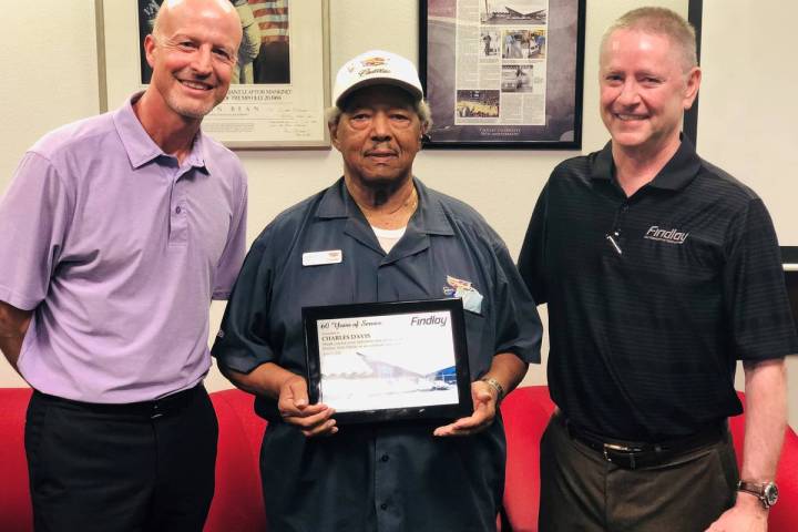 Longtime Findlay Automotive Group employee Charles Davis, center, is flanked by Findlay Automot ...