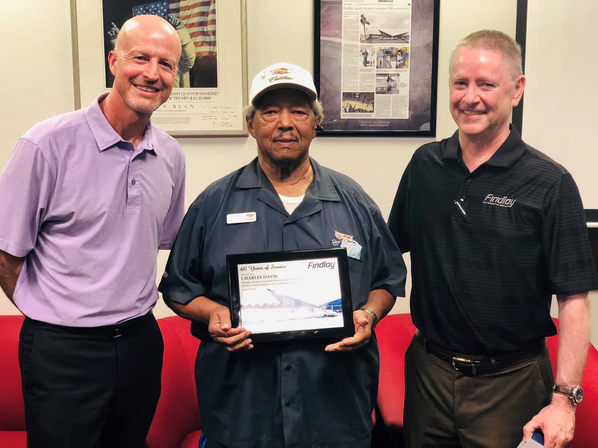 Longtime Findlay Automotive Group employee Charles Davis, center, is flanked by Findlay Automot ...