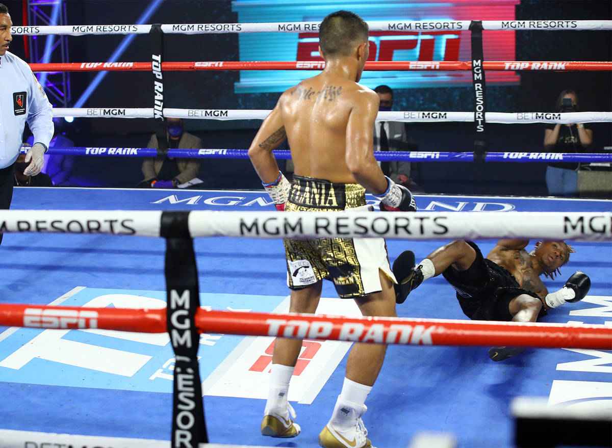 Mike Plania knocks down Joshua Greer Jr. during their bantamweight fight inside the MGM Grand's ...