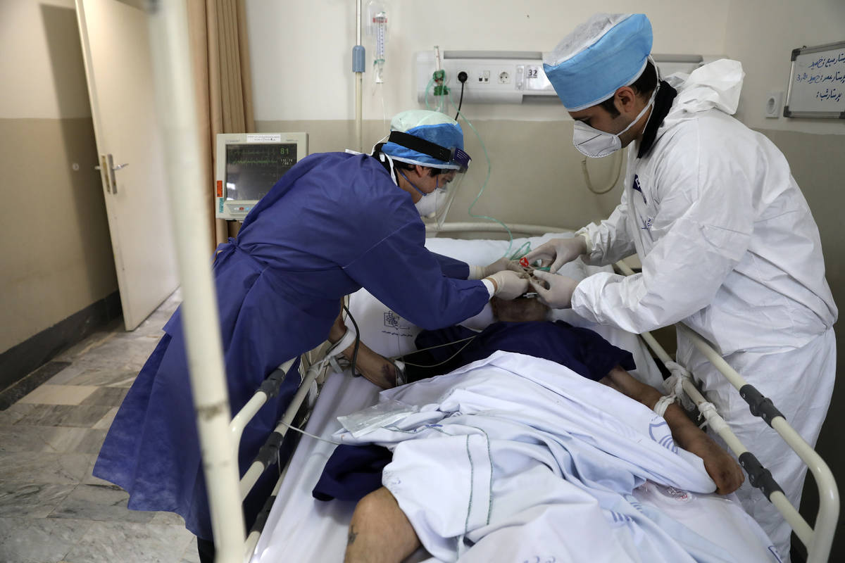 In this Tuesday, June 16, 2020, photo, medics tend to a COVID-19 patient at the Shohadaye Tajri ...