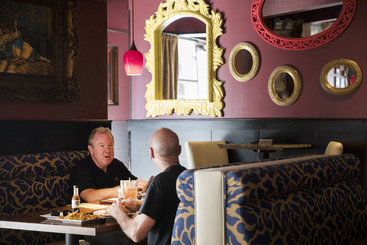 Andre Nelms, left, has lunch with Joe Giordano at Paymon's, a Mediterranean restaurant, in Las ...