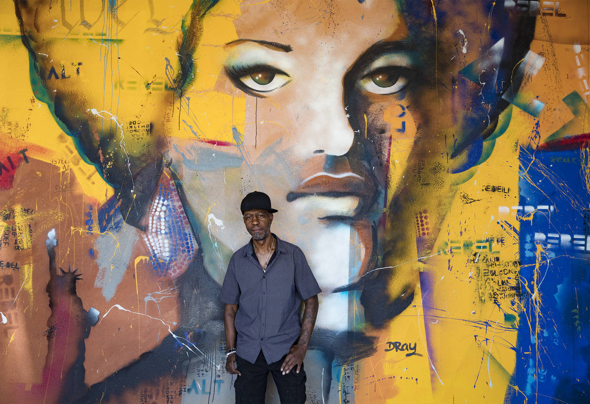 Dray stands in front of his mural of Kathleen Cleaver, a Black Panthers organizer, at Alt-Rebel ...