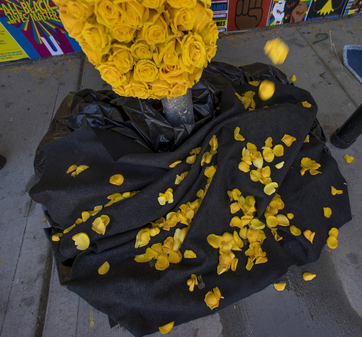Real yellow rose petals are dropped about a bleeding heart shaped display as the experiential c ...