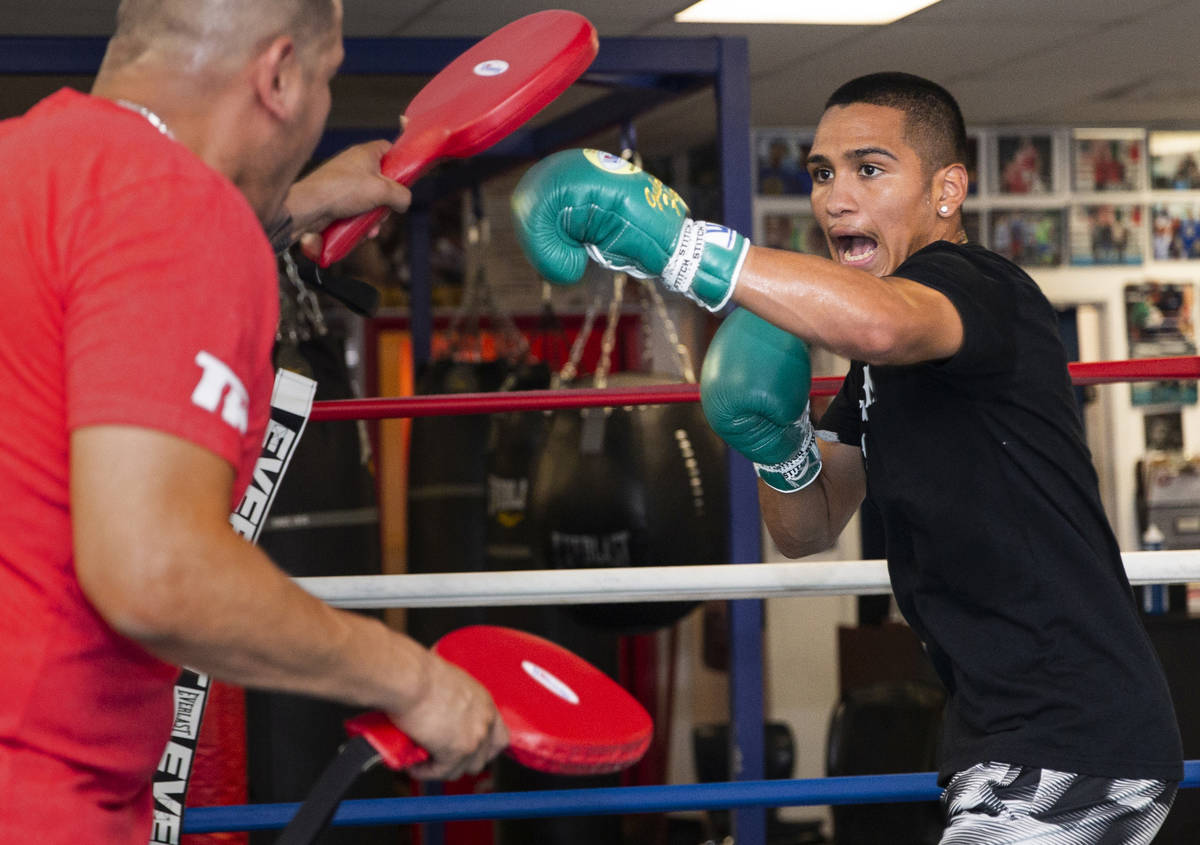 Gabe Flores Jr., right, works out with his trainer and father Gabriel Flores Sr. at Capetillo & ...