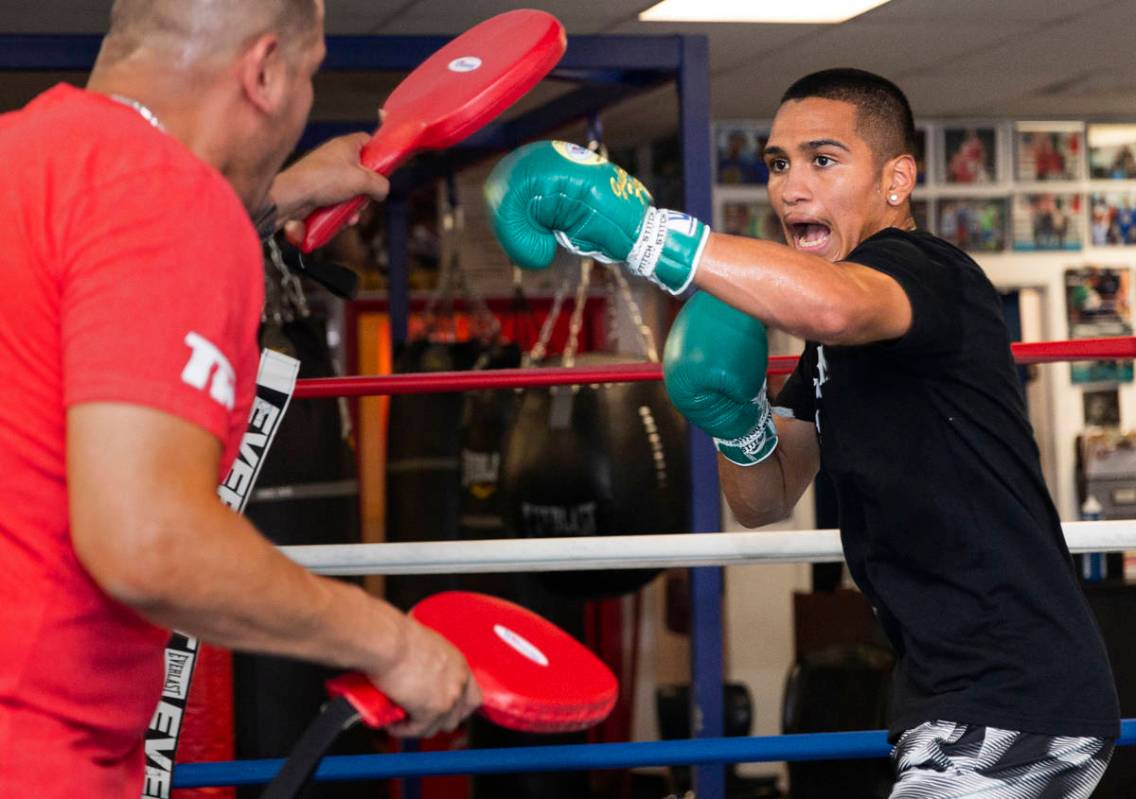 Gabe Flores Jr., right, works out with his trainer and father Gabriel Flores Sr. at Capetillo & ...