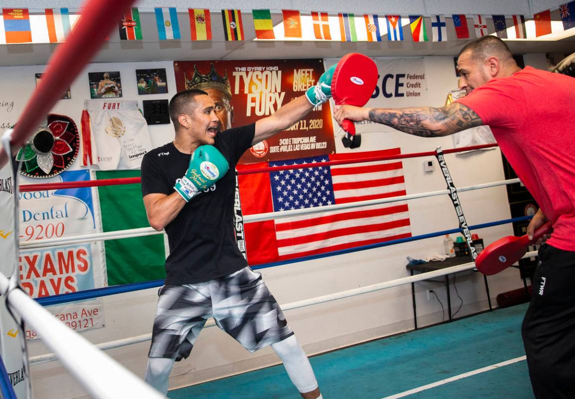 Gabe Flores Jr., left, works out with his trainer and father Gabriel Flores Sr. at Capetillo &a ...