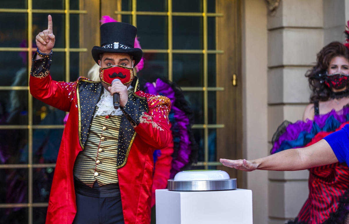 A Monsieur Loyal ringmaster counts down the final seconds outside the entrance of the Paris Las ...