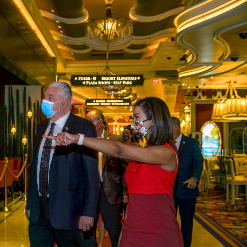 Gov. Steve Sisolak walks beside Sandra Morgan, chairwoman of the Nevada Gaming Control Board, a ...