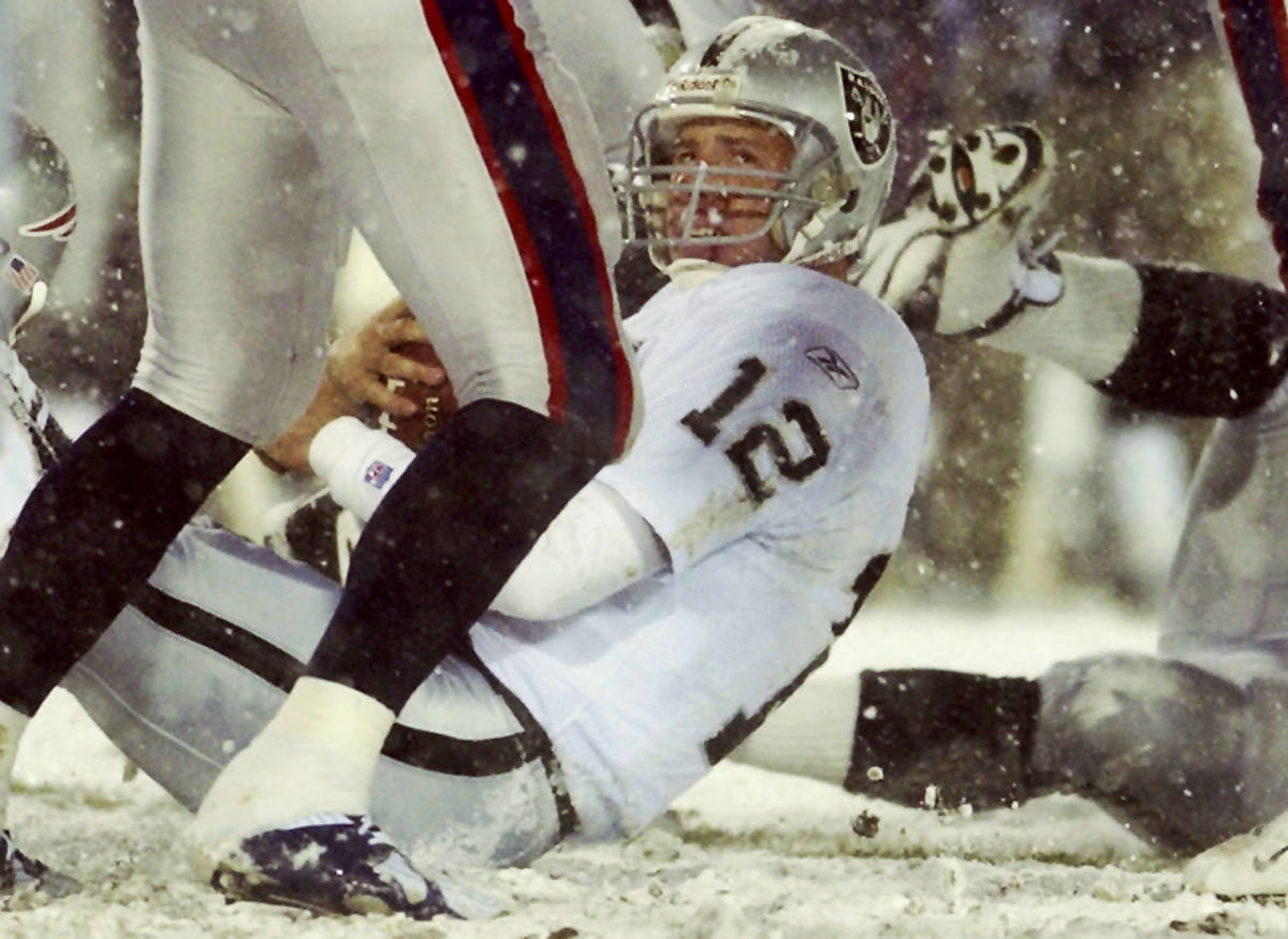Oakland Raiders quarterback Rich Gannon looks up after he was sacked by the New England Patriot ...