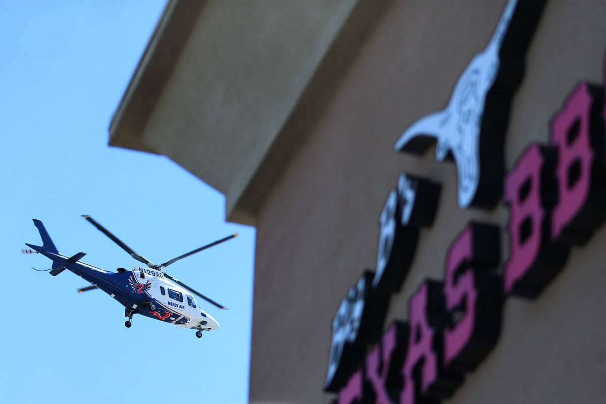 A Mercy Air helicopter flies over a fundraiser in support for wounded Las Vegas police officer ...