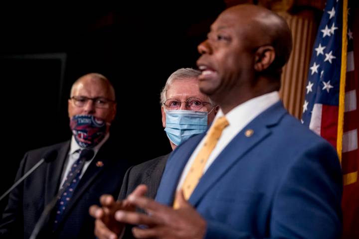 Sen. Tim Scott, R-S.C., right, accompanied by Senate Majority Leader Mitch McConnell of Ky., se ...