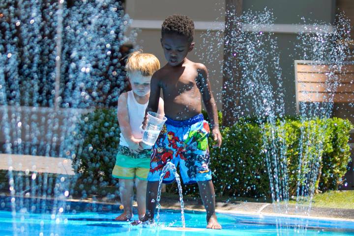 Mason Lanni, 2, left, and Mason, who declined to give his last name, play at a splash pad at Th ...