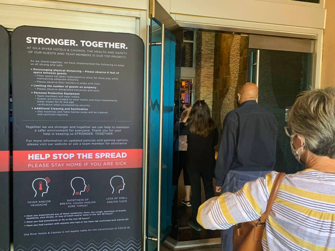 Individuals enter Gila River Casino at the Wild Horse Pass location on the packed reopening day ...