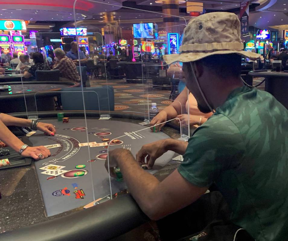 Individuals play table games at Gila River Casino at the Wild Horse Pass location on the packed ...