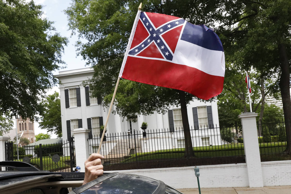 In this April 25, 2020 photograph, a small Mississippi state flag is held by a participant duri ...