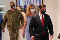 Arizona Gov. Doug Ducey, right, arrives to give an update on COVID-19 in Arizona during a news ...