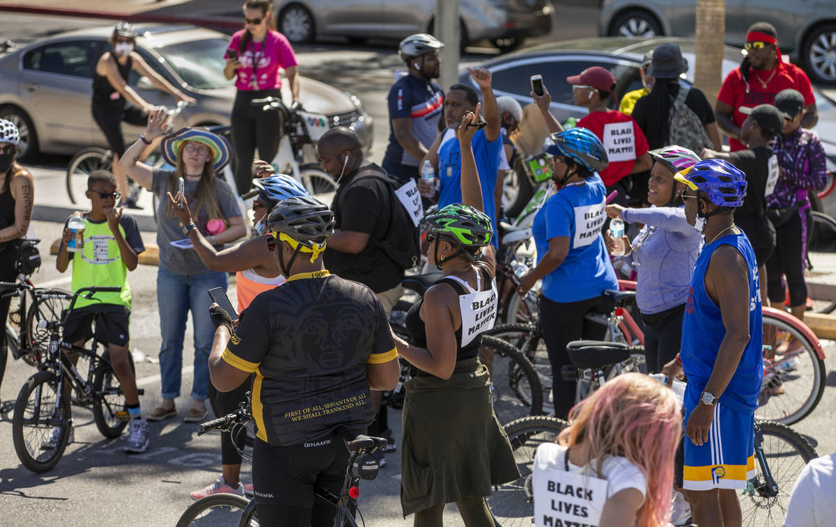 Participants in a Black Lives Matter bike ride against injustice cheer after returning to a par ...