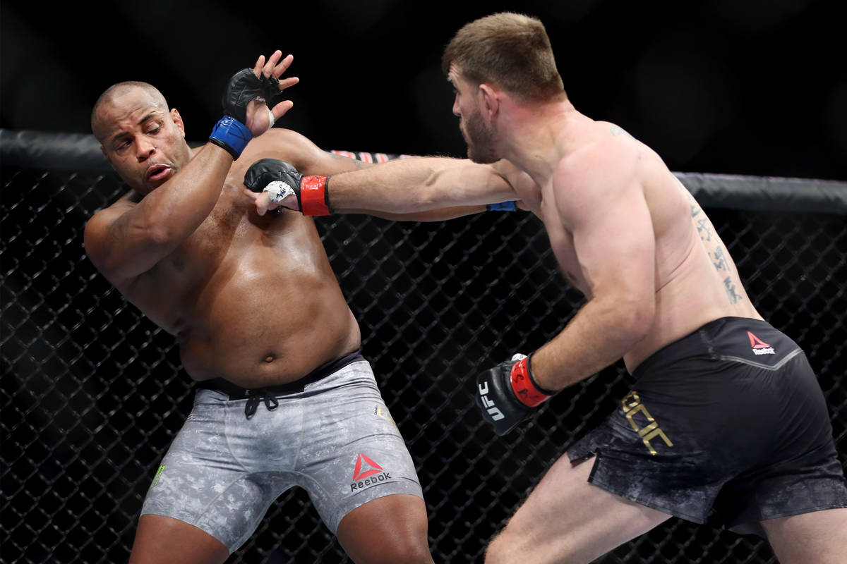 Stipe Miocic, right, battles Daniel Cormier in the heavyweight title bout during UFC 226 at T-M ...
