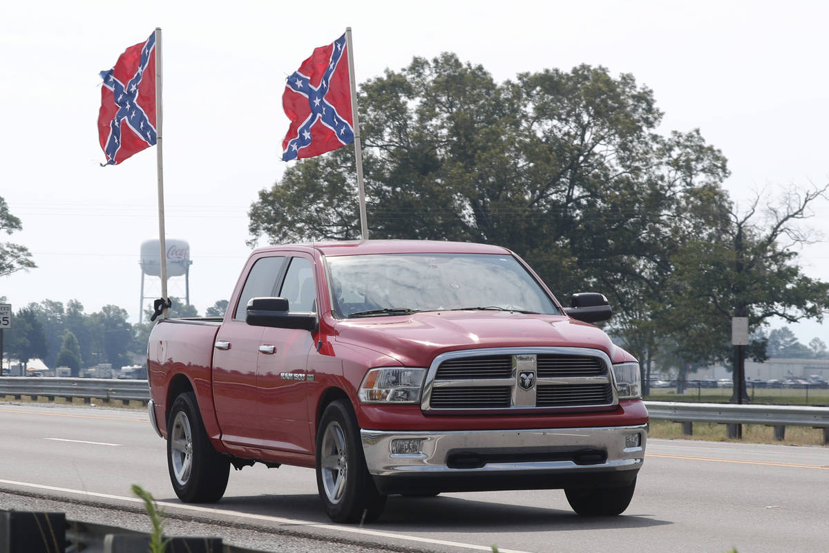 A truck flying Confederate flags passes by the Talladega Superspeedway prior to the NASCAR Cup ...