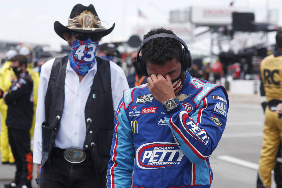 Driver Bubba Wallace, right, is overcome with emotion as he and team owner Richard Petty walk t ...
