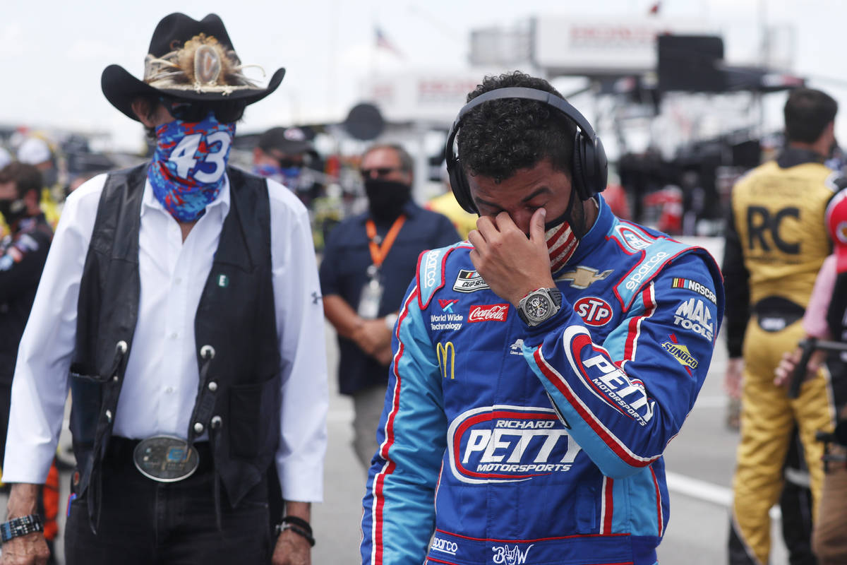 Driver Bubba Wallace, right, is overcome with emotion as he and team owner Richard Petty walk t ...