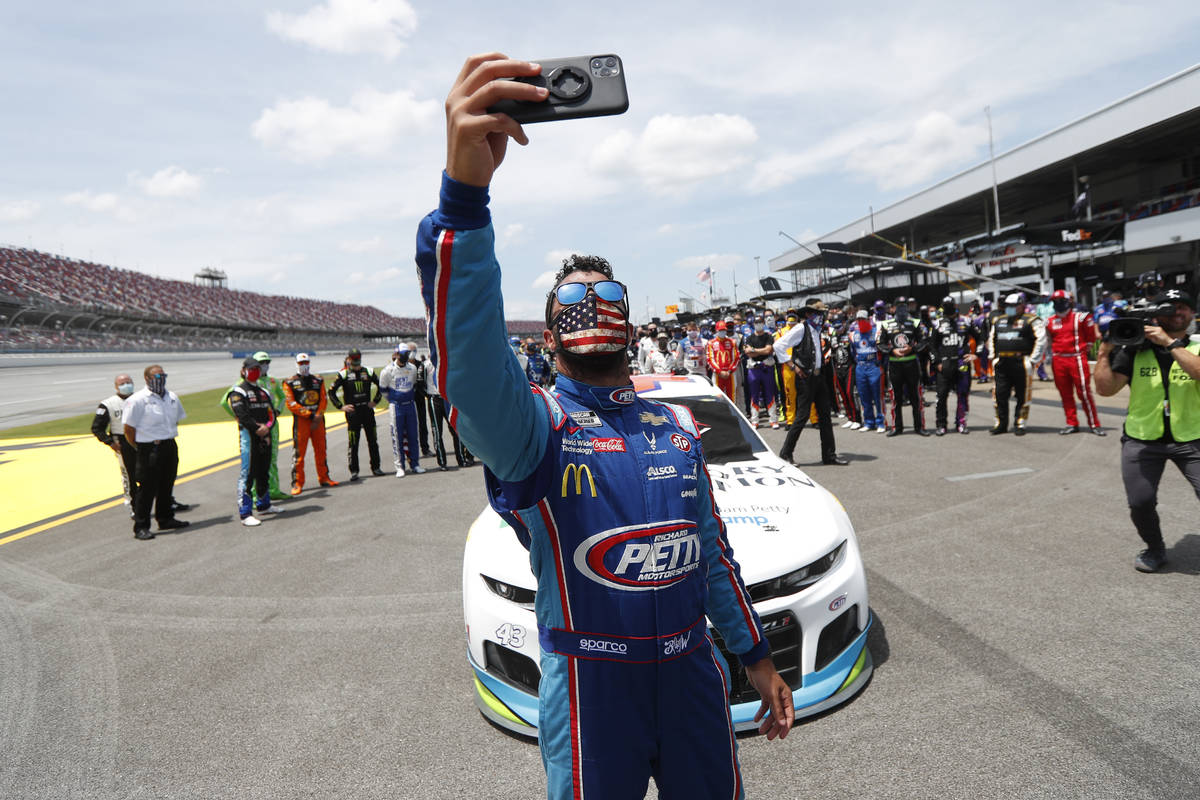 Driver Bubba Wallace takes a selfie with himself and other drivers that pushed his car to the f ...